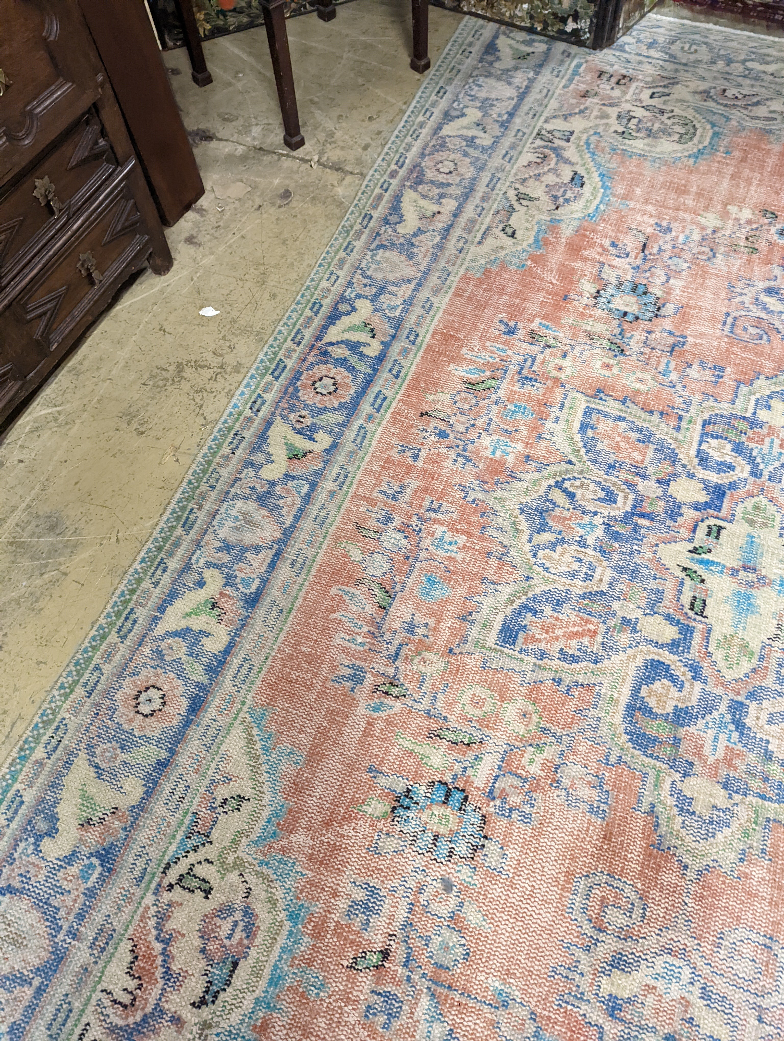 A North West Persian style faded wool carpet, 300 x 196cm